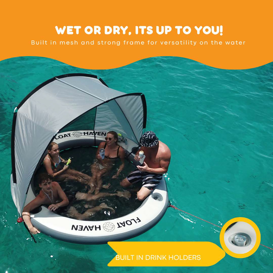 Family relaxing on a Float Haven inflatable floating island with shade canopy and built-in drink holders on turquoise water.