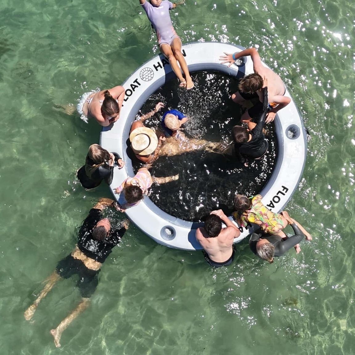 Families and friends enjoying the Float Haven inflatable island, creating fun memories together on the water.