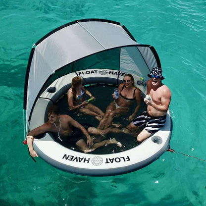 People enjoying a Float Haven inflatable island with Shade in clear blue water 